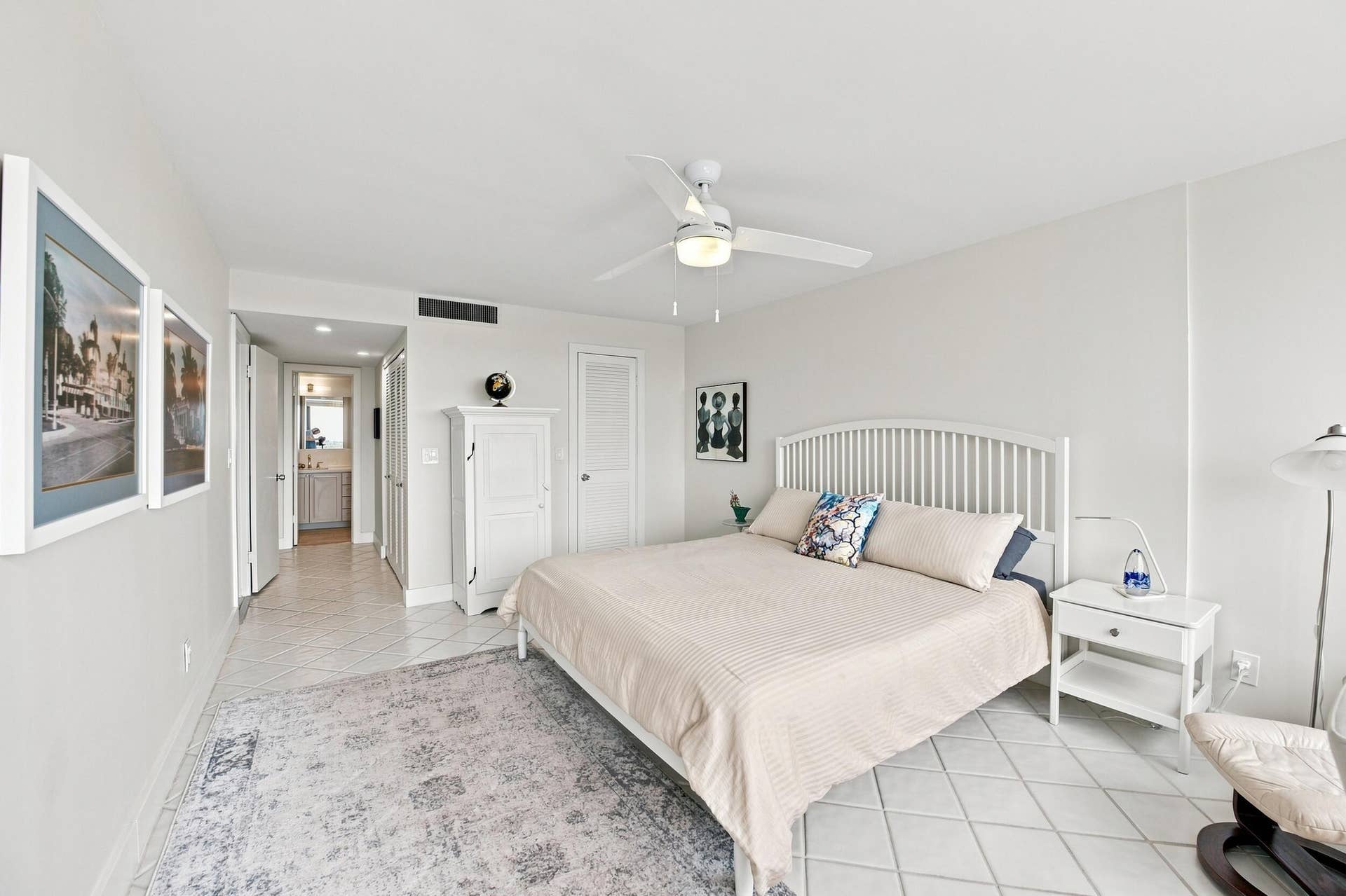 3589 S Ocean Boulevard, #808, South Palm Beach, FL 33480 Very Spacious Primary Neutral-toned bedroom featuring white tile flooring and a ceiling fan with integrated lighting