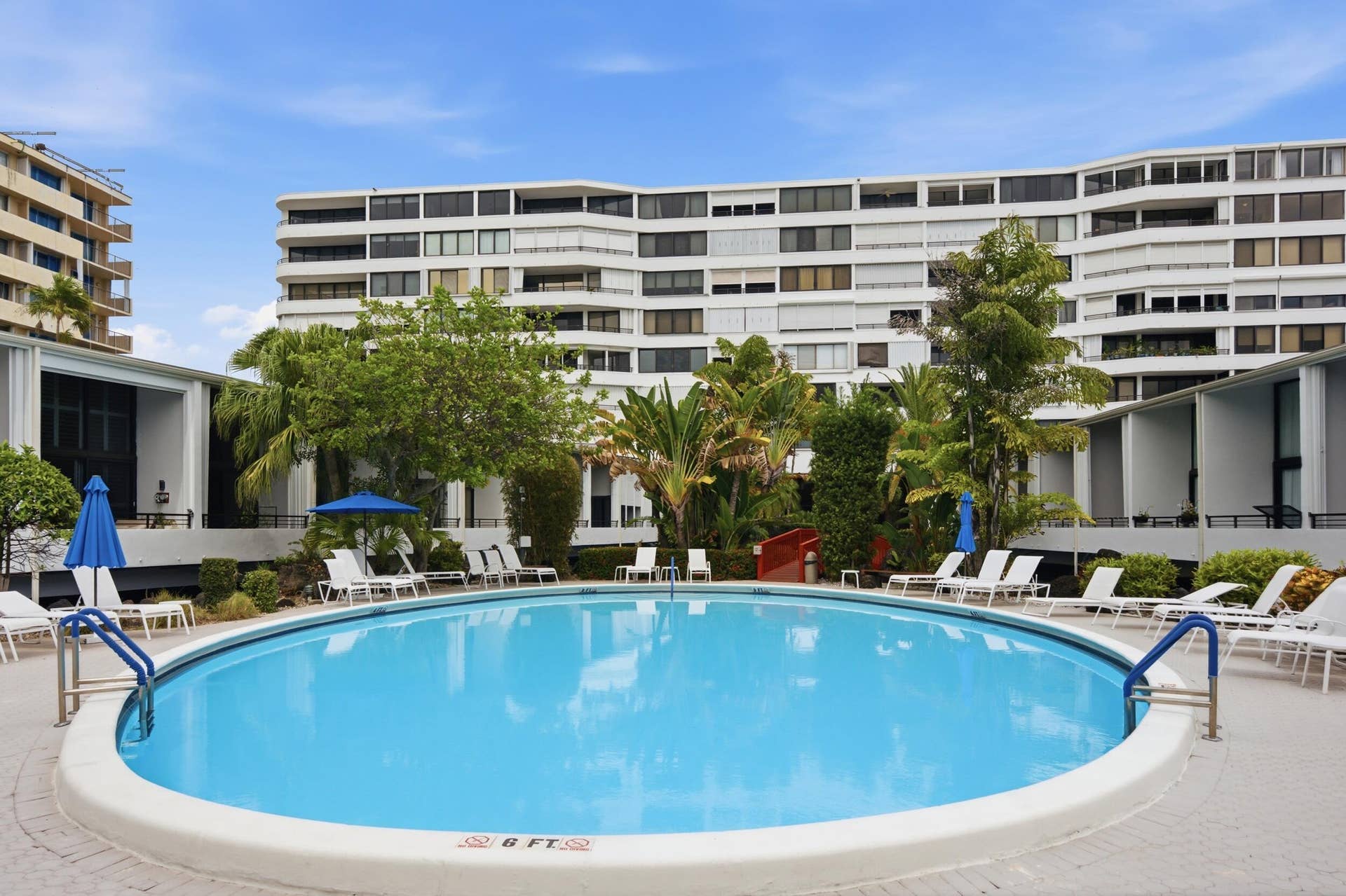3589 S Ocean Boulevard, #808, South Palm Beach, FL 33480 Circular swimming pool with a white coping, surrounded by a light-colored paver deck