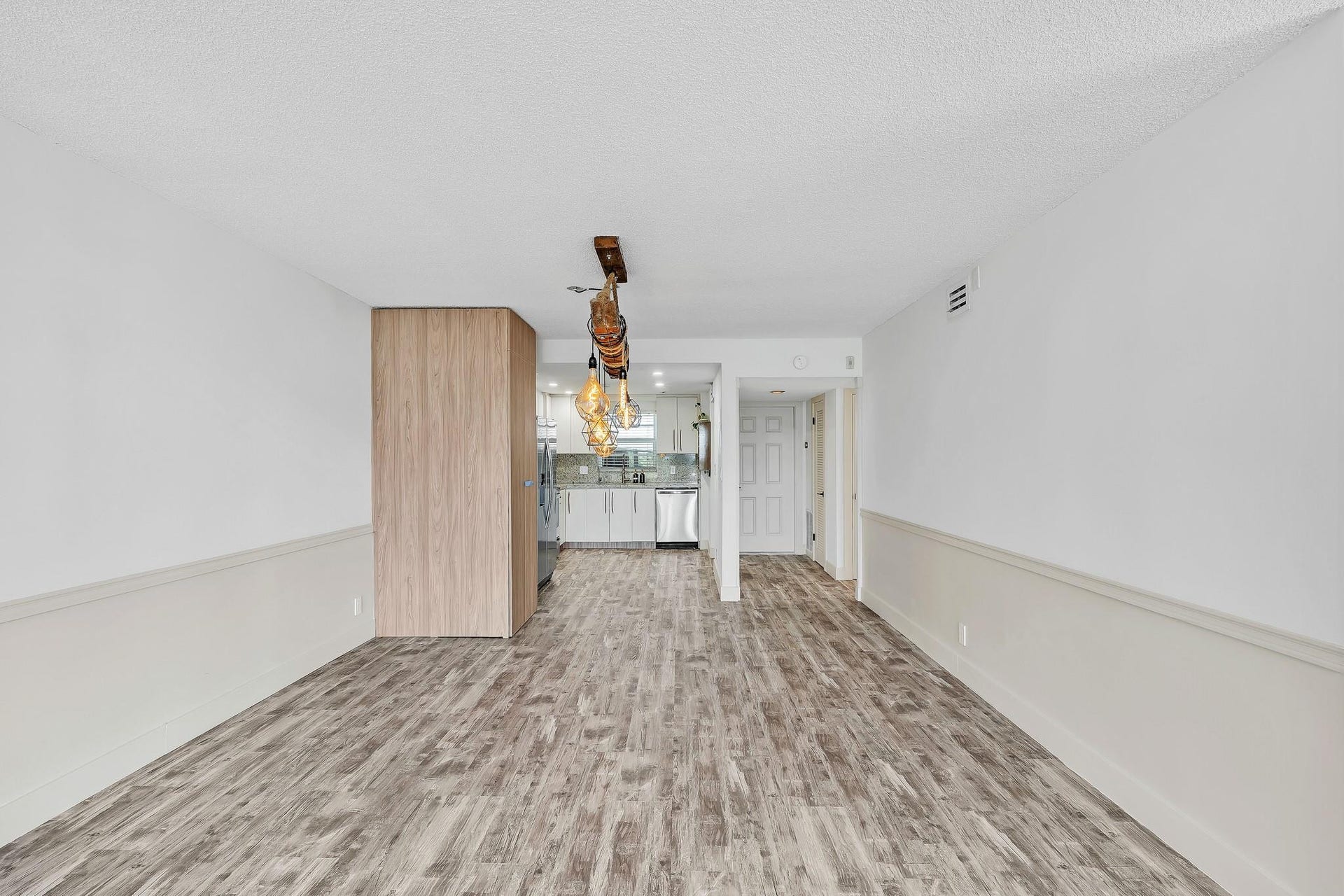 3051 NE 48TH Street, #301, Fort Lauderdale, Fort Lauderdale, FL 33308 Wood-finish flooring throughout, complemented by a chair rail