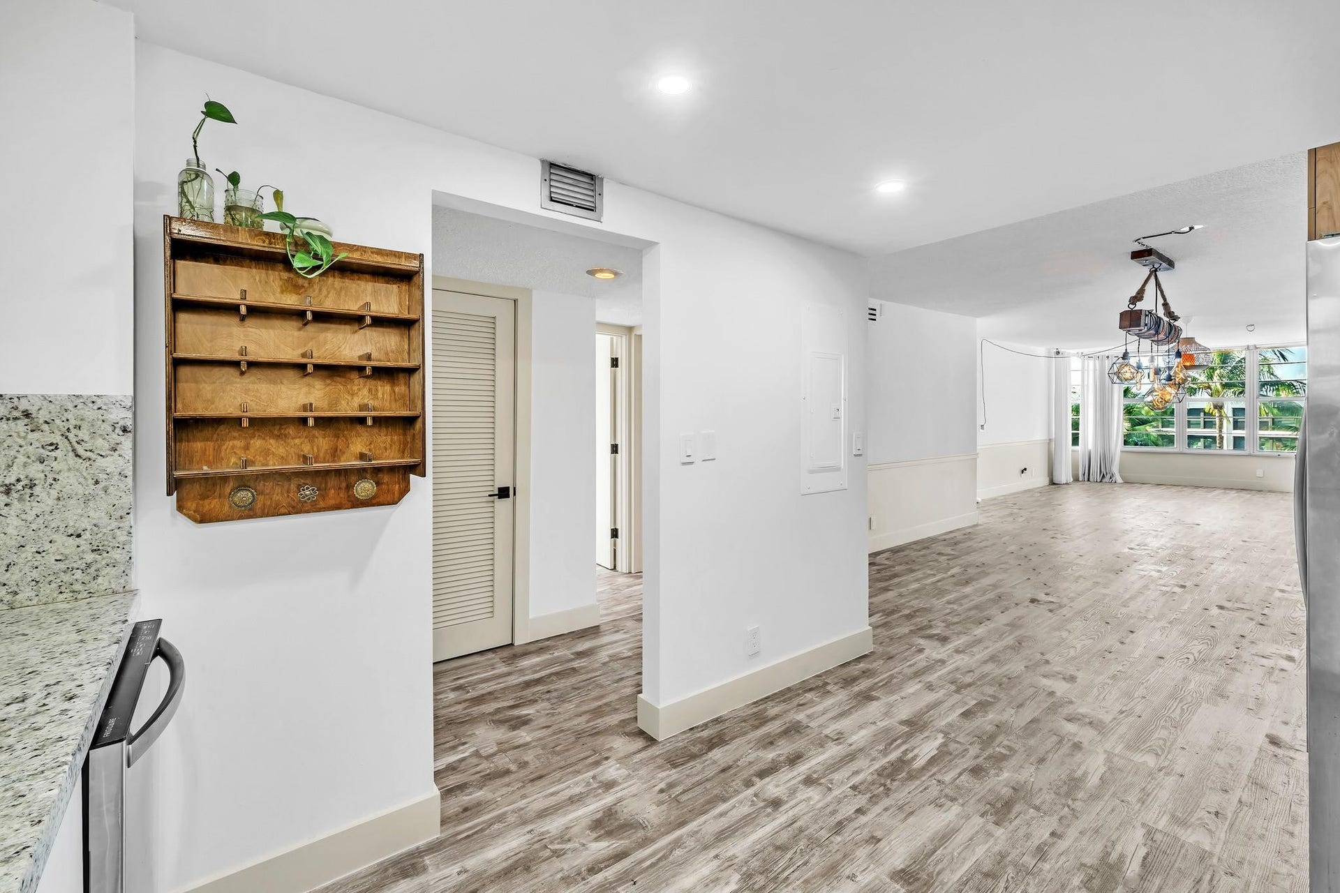 3051 NE 48TH Street, #301, Fort Lauderdale, Fort Lauderdale, FL 33308 Wood-finish flooring throughout, white baseboards, recessed lighting, and a modern multi-light fixture