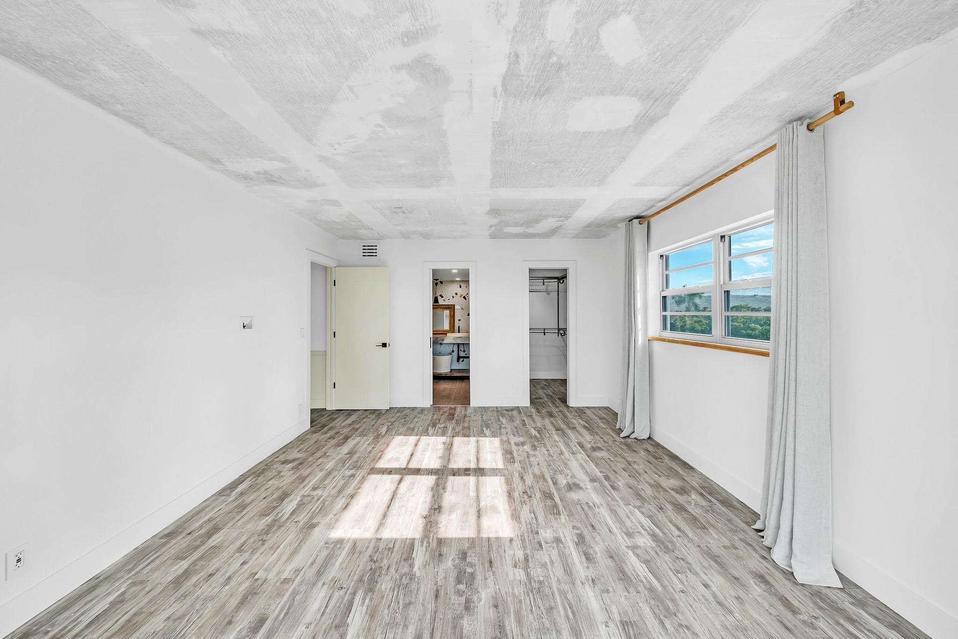 3051 NE 48TH Street, #301, Fort Lauderdale, Fort Lauderdale, FL 33308 Wood-finish flooring, white walls, and a window with a wood sill