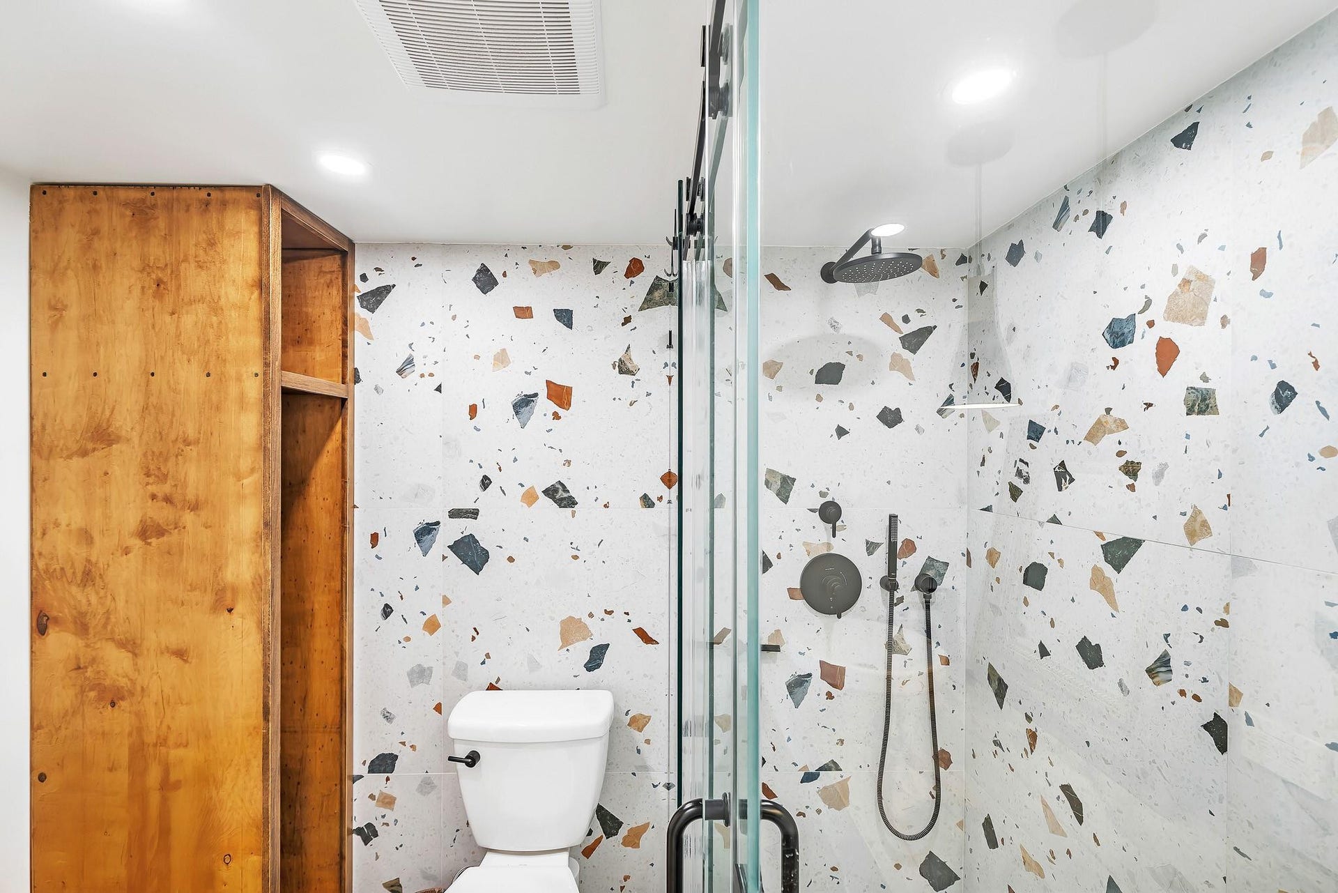 3051 NE 48TH Street, #301, Fort Lauderdale, Fort Lauderdale, FL 33308 Glass-enclosed shower with matte black fixtures, rain shower head, and colorful terrazzo-style tile
