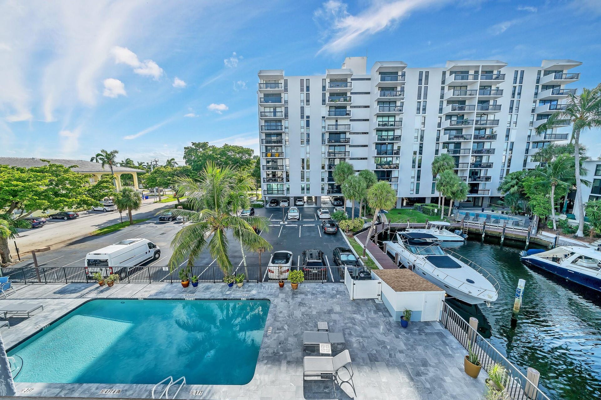 3051 NE 48TH Street, #301, Fort Lauderdale, Fort Lauderdale, FL 33308 Outdoor swimming pool with a paved deck, directly adjacent to a waterway with boat docks