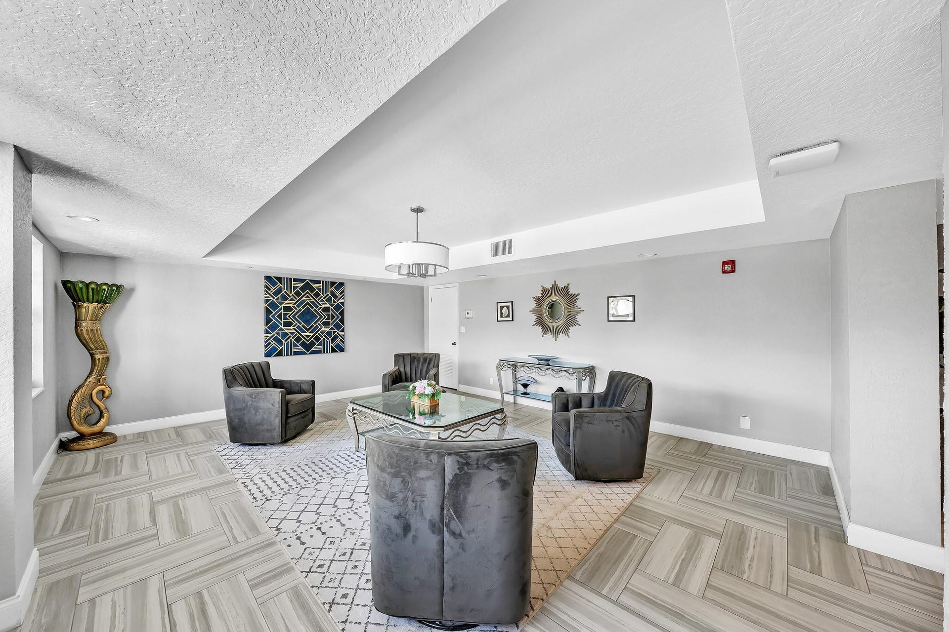 3051 NE 48TH Street, #301, Fort Lauderdale, Fort Lauderdale, FL 33308 Recessed lighting, contemporary chandelier, textured ceiling, tiled flooring with a herringbone pattern, light gray wall color