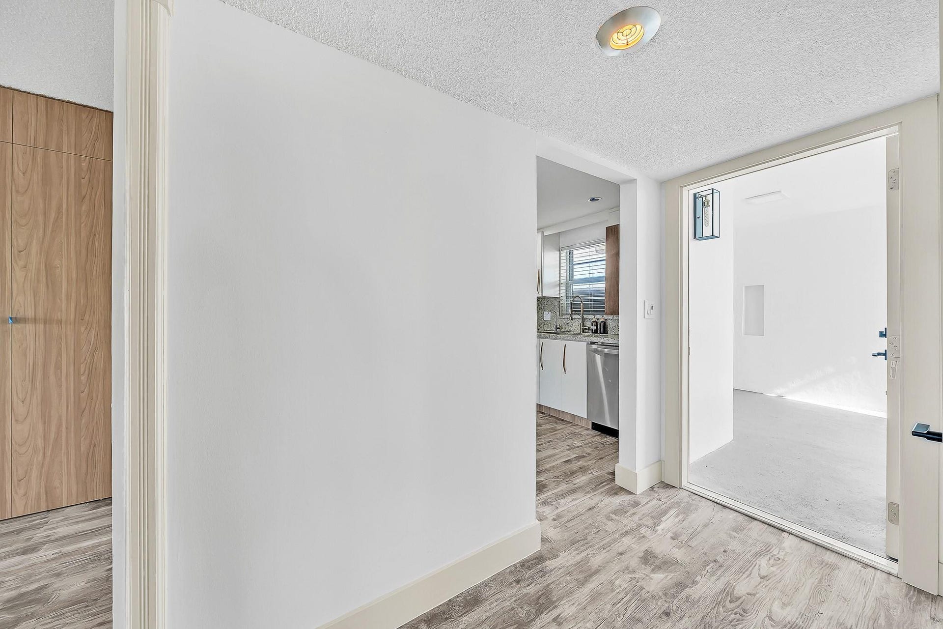 3051 NE 48TH Street, #301, Fort Lauderdale, Fort Lauderdale, FL 33308 Wood-finish flooring throughout, with a neutral white wall finish and a built-in kitchen featuring stainless steel appliances