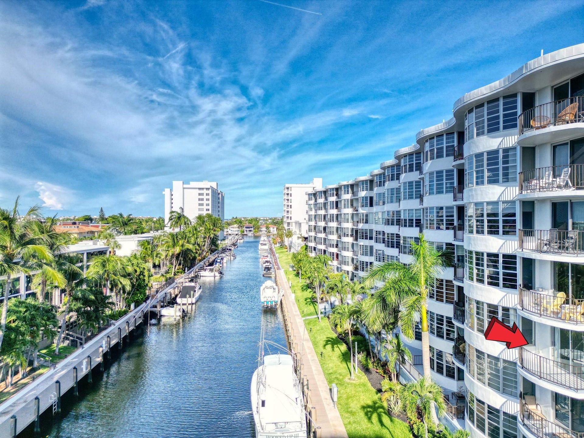 3051 NE 48TH Street, #301, Fort Lauderdale, Fort Lauderdale, FL 33308 Waterfront building with multiple balconies and a manicured green space
