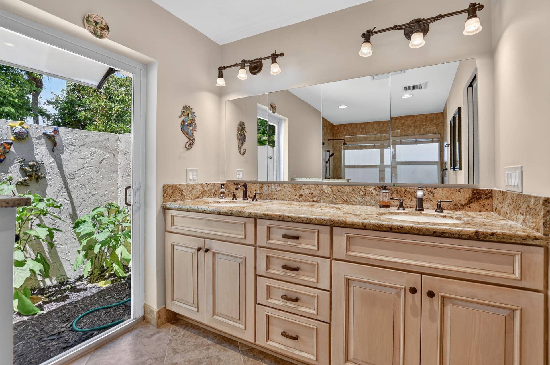 Dual vanity with granite countertops, individual sinks, and bronze-finish fixtures