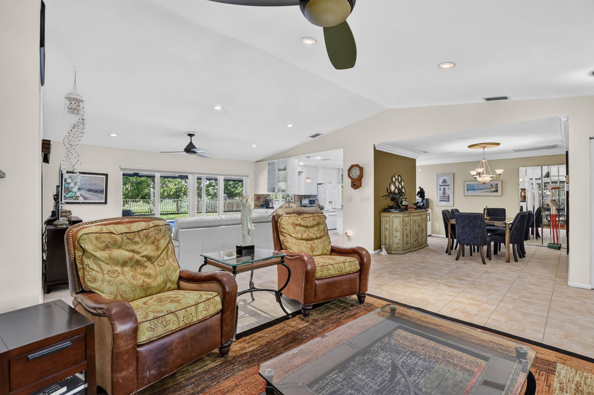 Vaulted ceilings, recessed lighting, and a contemporary ceiling fan