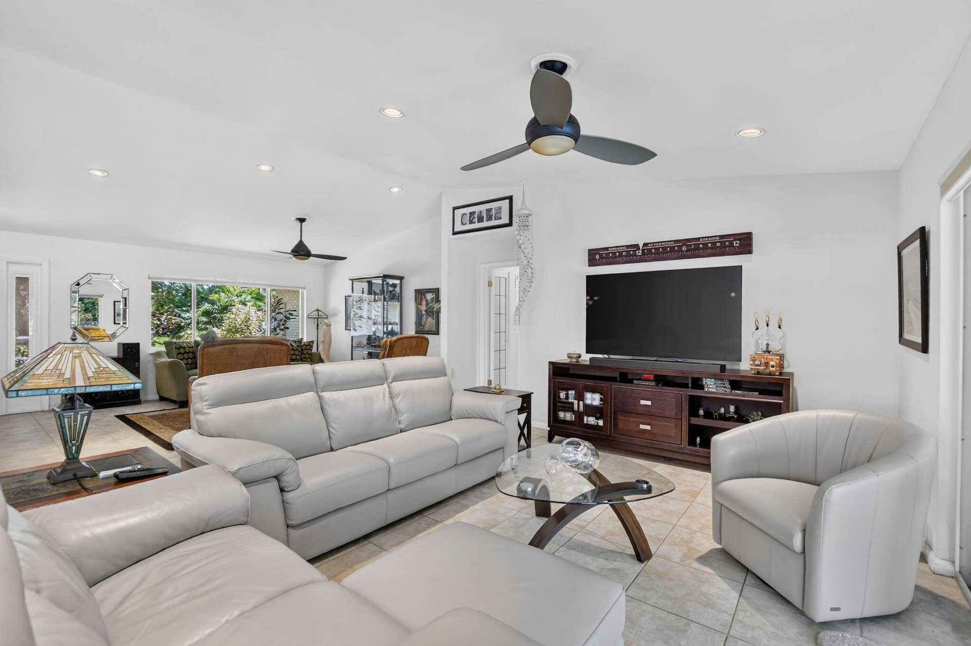 Vaulted ceilings with recessed lighting, tile flooring, and multiple ceiling fans