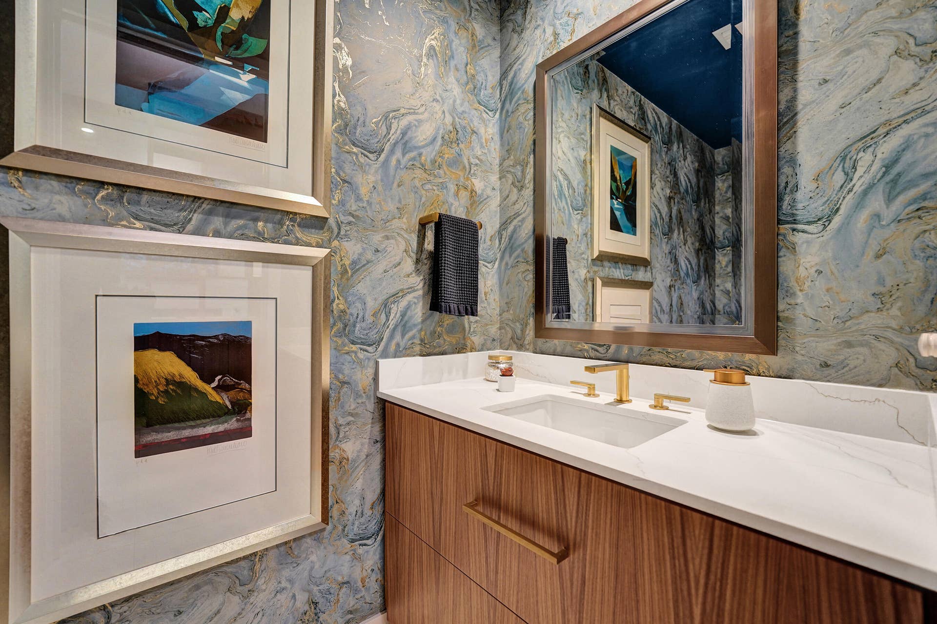 Custom vanity with gold-tone hardware, undermount sink, and a white countertop