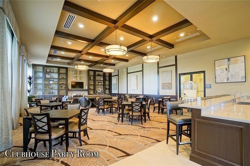9749 Blue Isle, #BAY, Parkland, FL 33076 Tray ceiling with dark wood beams, recessed lighting, and modern pendant fixtures