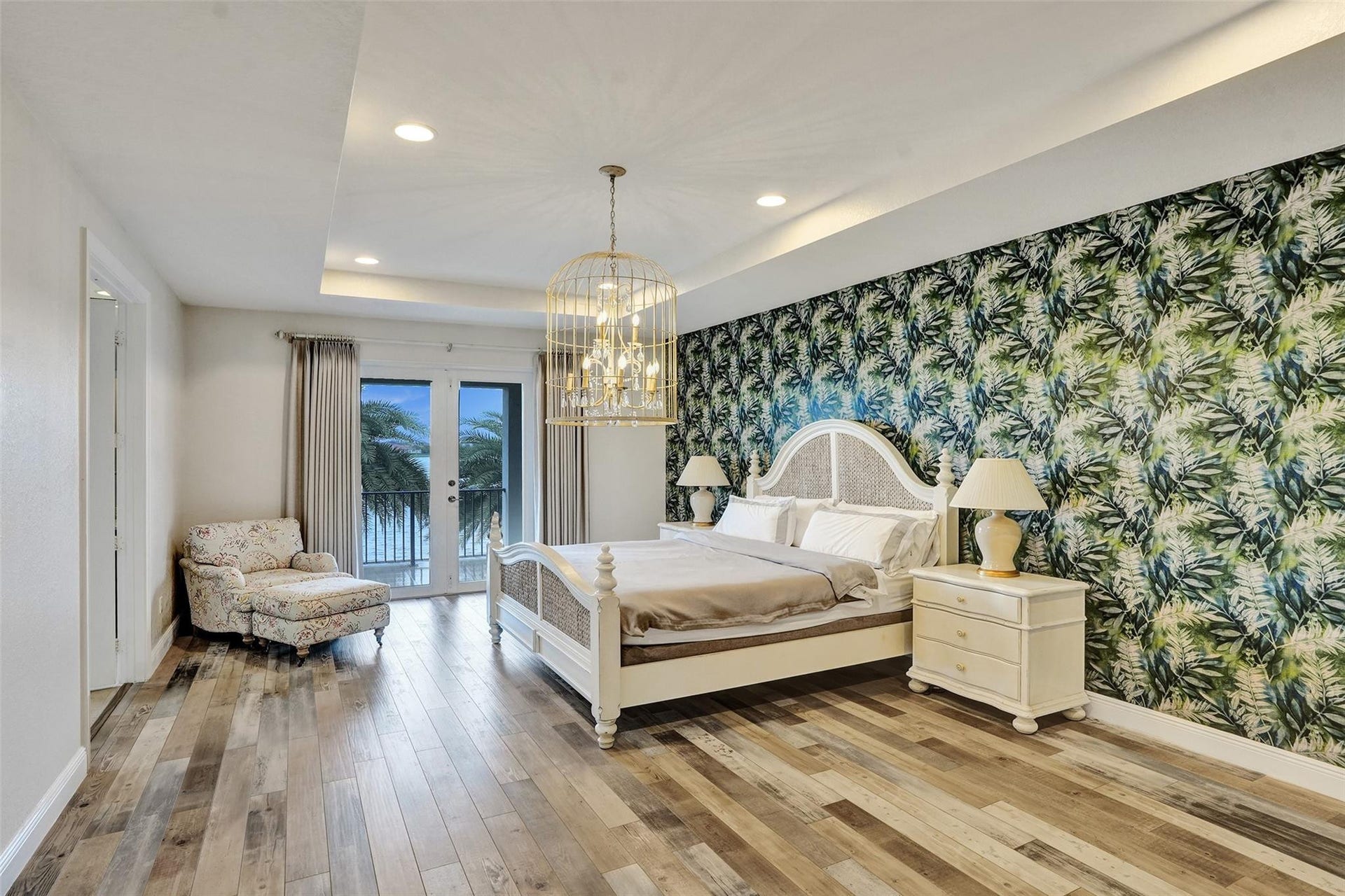 9749 Blue Isle, #BAY, Parkland, FL 33076 Wood-finish flooring, recessed lighting, double French doors, accent wall with botanical pattern, and tray ceiling