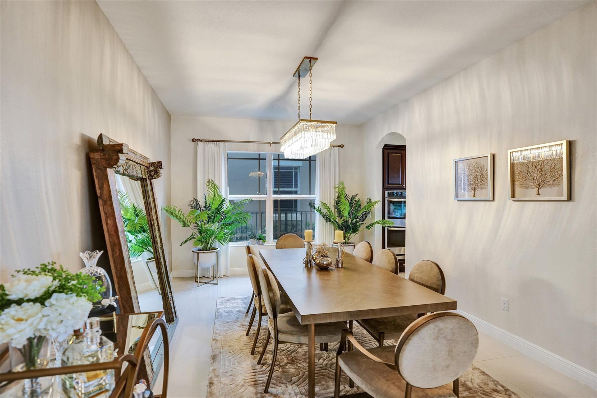9749 Blue Isle, #BAY, Parkland, FL 33076 Recessed lighting illuminates the dining area, featuring a rectangular chandelier, arched doorway, and tiled flooring