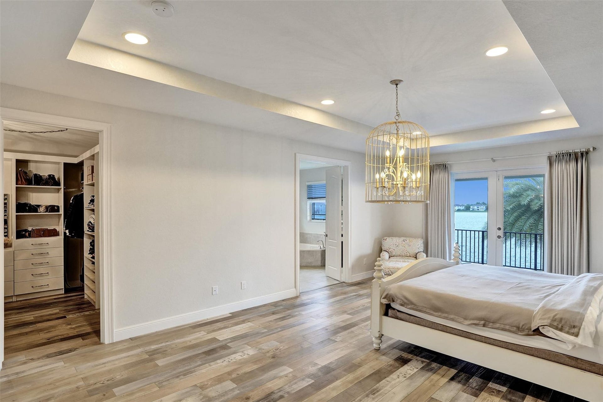 9749 Blue Isle, #BAY, Parkland, FL 33076 Tray ceiling with recessed lighting, wood-finish flooring, built-in closet storage, French doors, and balcony with metal railing