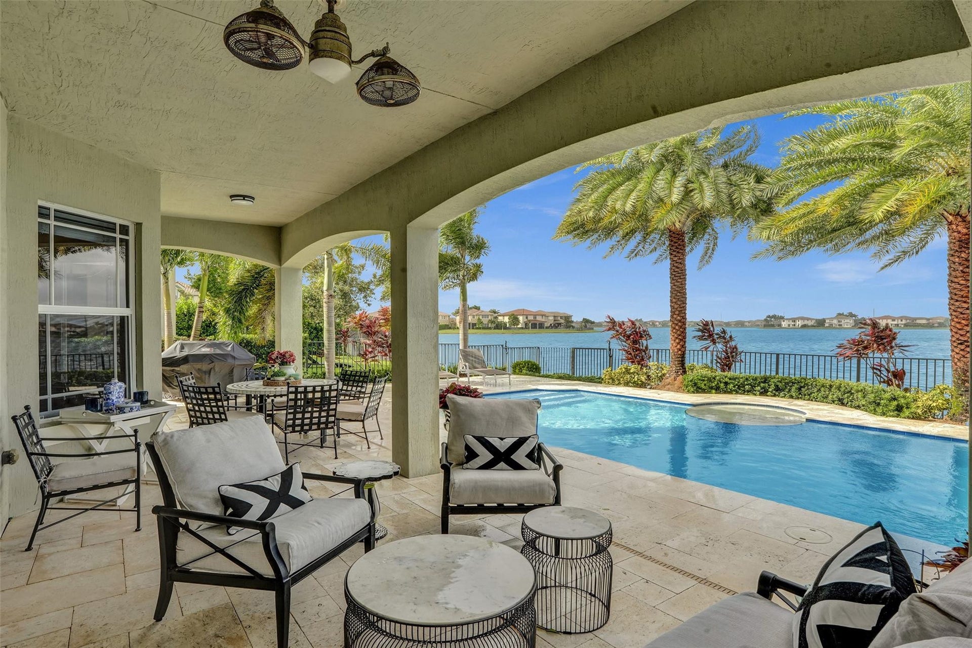 9749 Blue Isle, #BAY, Parkland, FL 33076 Covered patio with arched openings, an outdoor ceiling fan, and tiled flooring