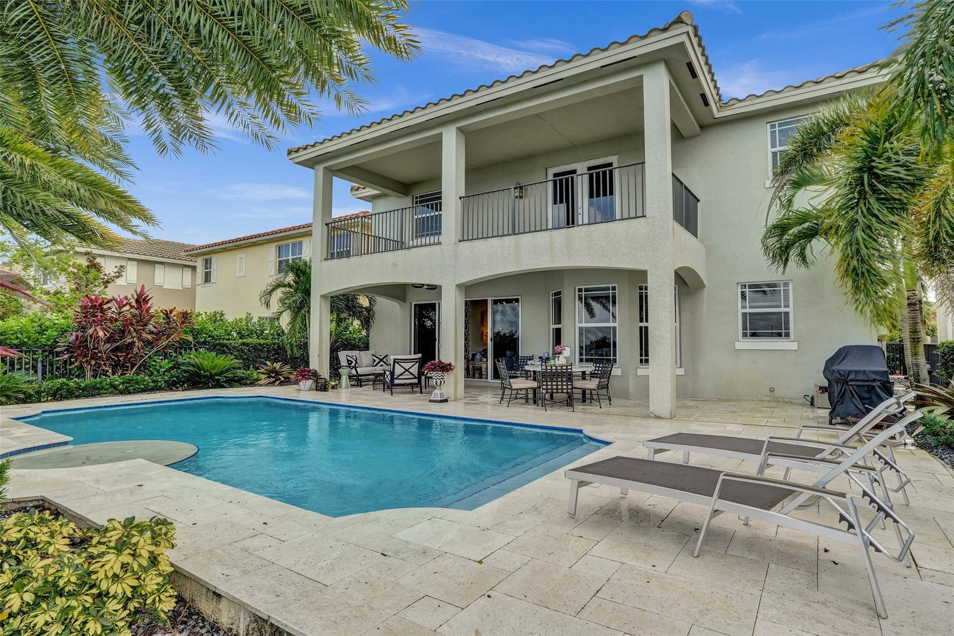 9749 Blue Isle, #BAY, Parkland, FL 33076 Expansive outdoor area featuring a swimming pool, travertine paver decking, and a covered patio