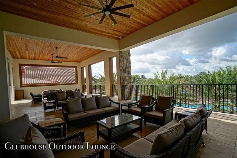 9749 Blue Isle, #BAY, Parkland, FL 33076 Expansive outdoor lounge featuring a wood-panel ceiling, multiple ceiling fans, stone pillar accents, and a tiled patio