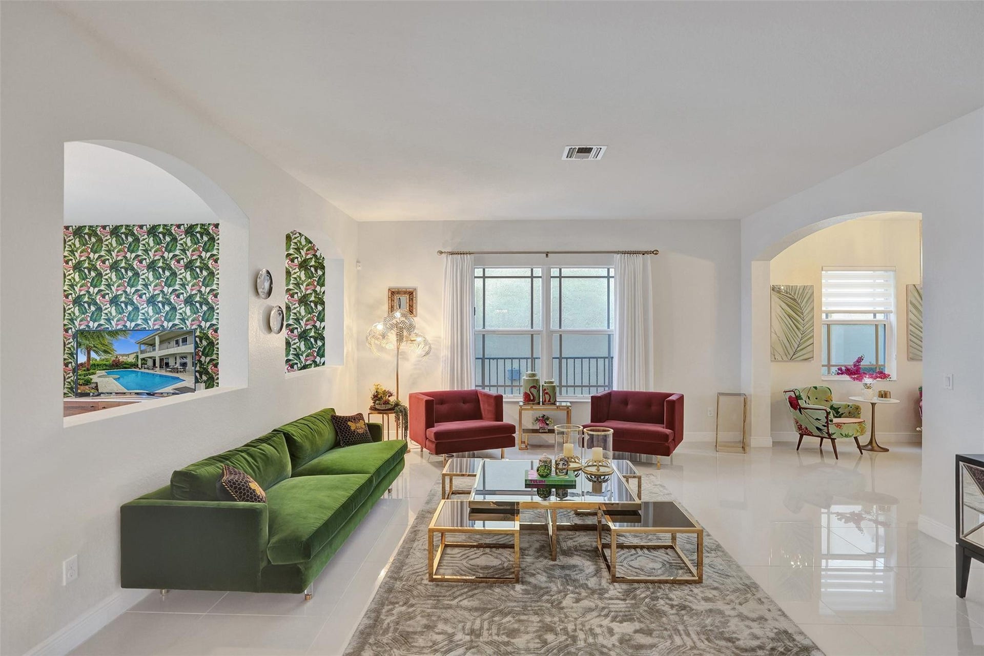 9749 Blue Isle, #BAY, Parkland, FL 33076 White tile flooring, arched doorways, a large window with privacy blinds, recessed lighting, and wall sconces