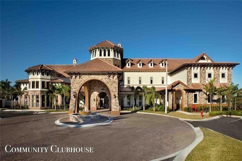 9749 Blue Isle, #BAY, Parkland, FL 33076 Clubhouse featuring a stone facade, a barrel tile roof, dormer windows, and a paver drive with a central fountain