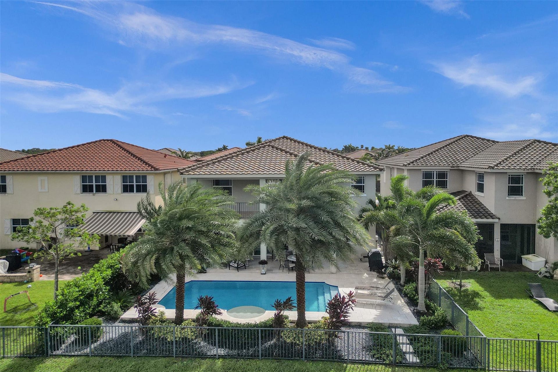 9749 Blue Isle, #BAY, Parkland, FL 33076 Expansive backyard with a swimming pool, integrated spa, and surrounding paved patio