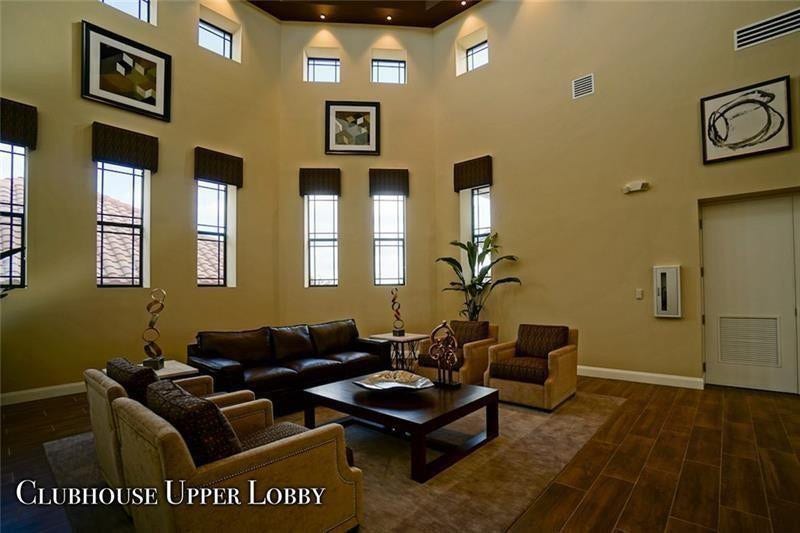9749 Blue Isle, #BAY, Parkland, FL 33076 Vaulted ceiling with recessed lighting, wood-finish flooring, and multiple tall windows