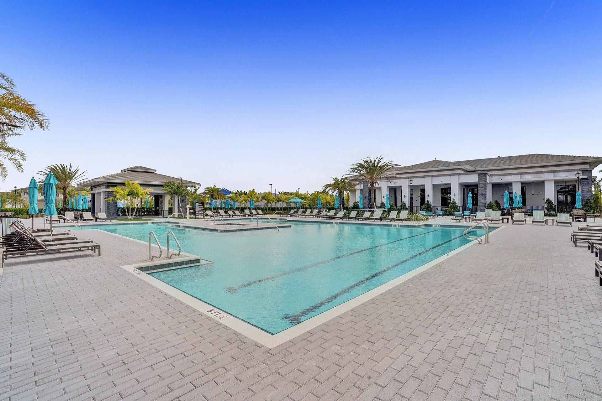 9749 Blue Isle, #BAY, Parkland, FL 33076 Expansive aquatic amenity featuring multiple pools, a paved deck, and a cabana structure