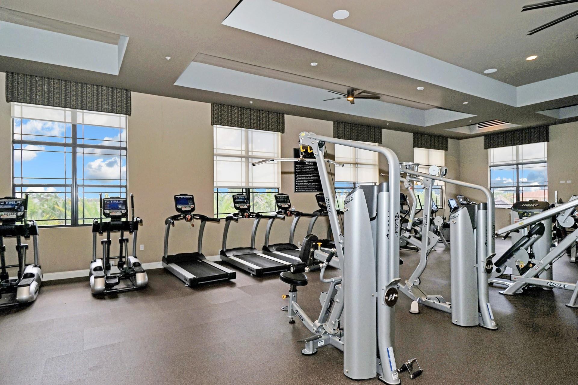 9749 Blue Isle, #BAY, Parkland, FL 33076 Fitness center featuring multiple cardio machines, strength training equipment, large windows, recessed lighting, and ceiling fans