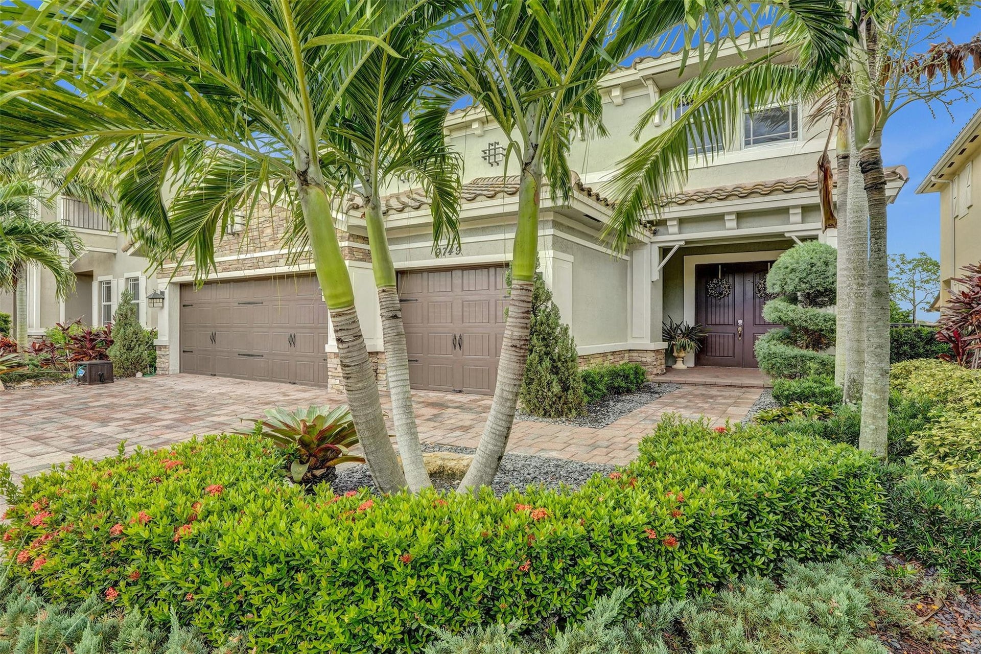 9749 Blue Isle, #BAY, Parkland, FL 33076 Expansive paver driveway leading to a two-car garage with arched doors
