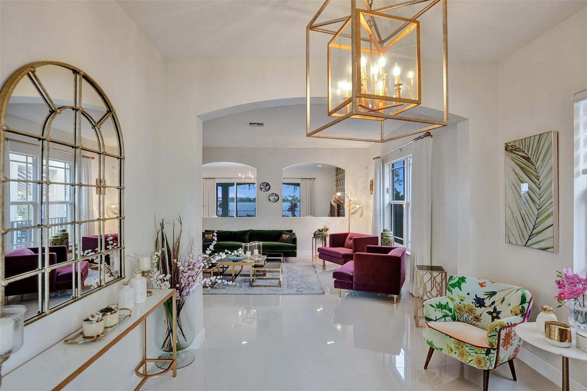 9749 Blue Isle, #BAY, Parkland, FL 33076 High ceilings with a prominent geometric chandelier, glossy tile flooring, arched doorways, and substantial windows
