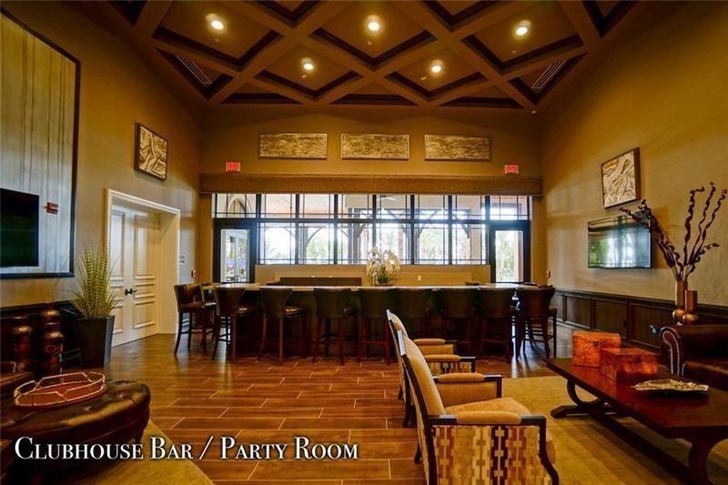 9749 Blue Isle, #BAY, Parkland, FL 33076 Wood-finish flooring, coffered ceiling with recessed lighting, full-length bar with bar stools, and a large window wall