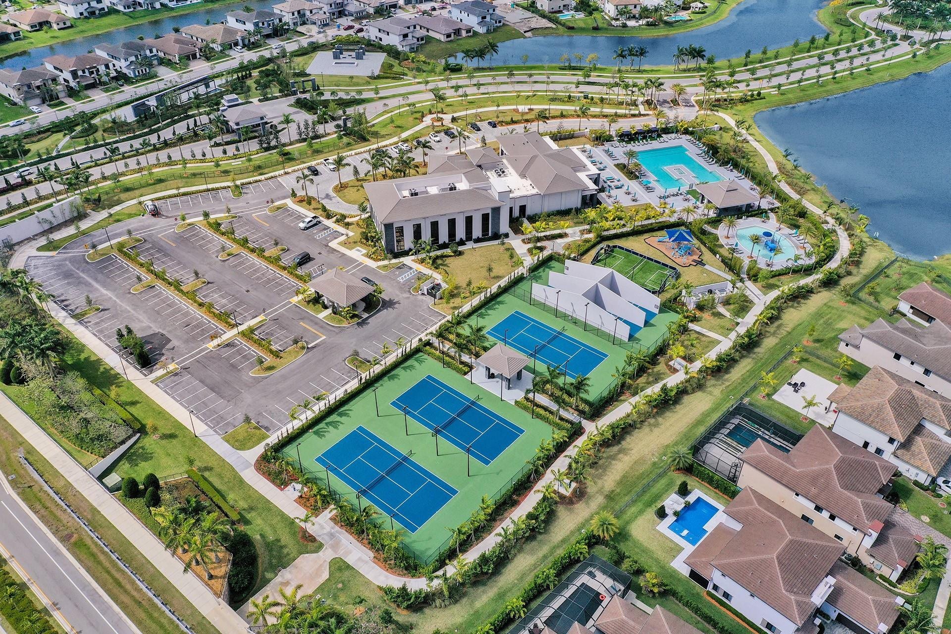 9749 Blue Isle, #BAY, Parkland, FL 33076 Community amenities featuring two tennis courts, multiple swimming pools, and a central clubhouse structure