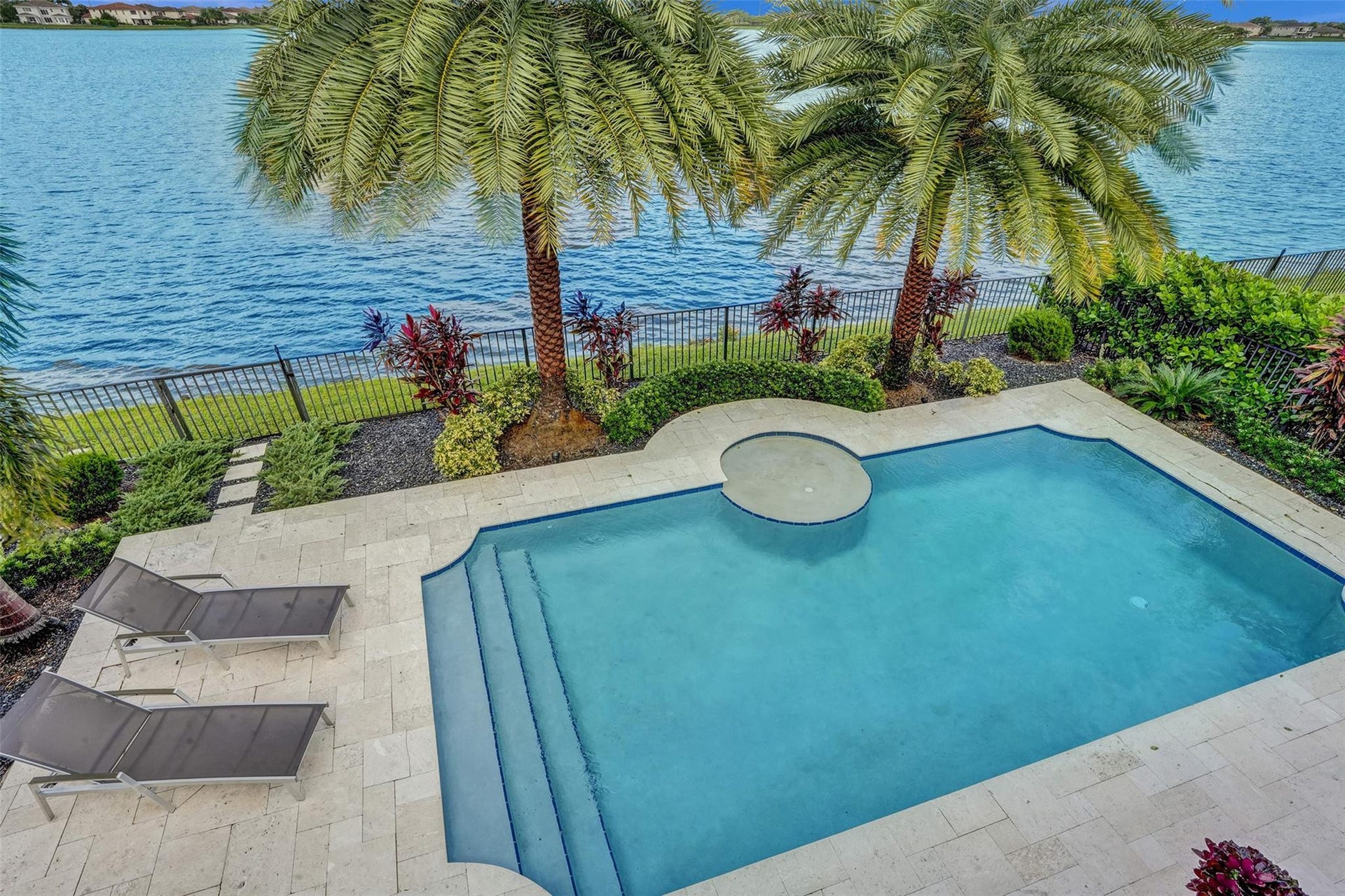 9749 Blue Isle, #BAY, Parkland, FL 33076 Swimming pool with integrated spa and broad steps, surrounded by a stone paver deck