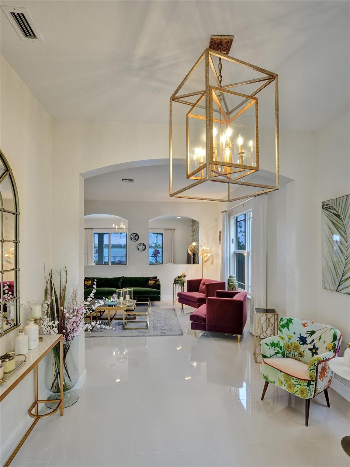 9749 Blue Isle, #BAY, Parkland, FL 33076 Spacious entryway featuring a decorative chandelier, archway, hard-surface flooring, and window