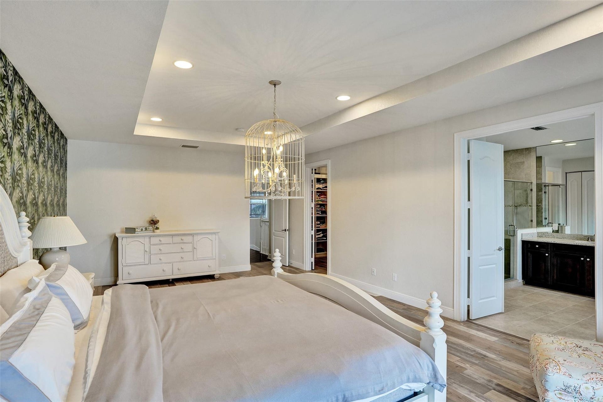 9749 Blue Isle, #BAY, Parkland, FL 33076 Tray ceiling with recessed lighting and a decorative chandelier