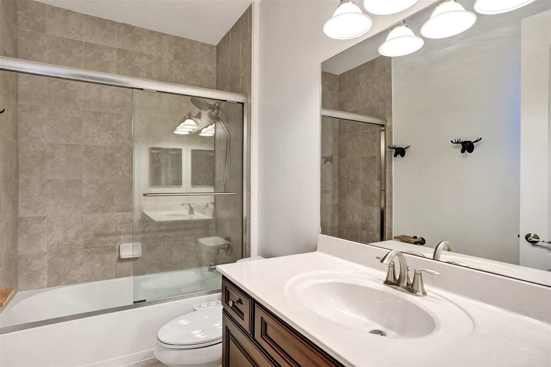 9749 Blue Isle, #BAY, Parkland, FL 33076 Bathroom vanity with an integrated sink, brushed nickel faucet, and a large mirror