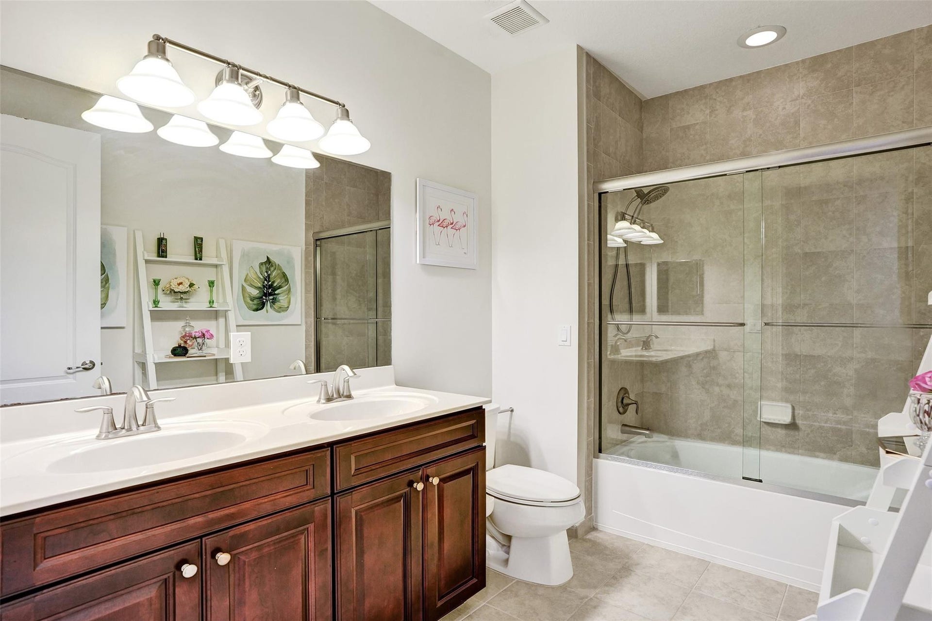 9749 Blue Isle, #BAY, Parkland, FL 33076 Dual vanity with wood cabinetry, full-width mirror, and overhead lighting