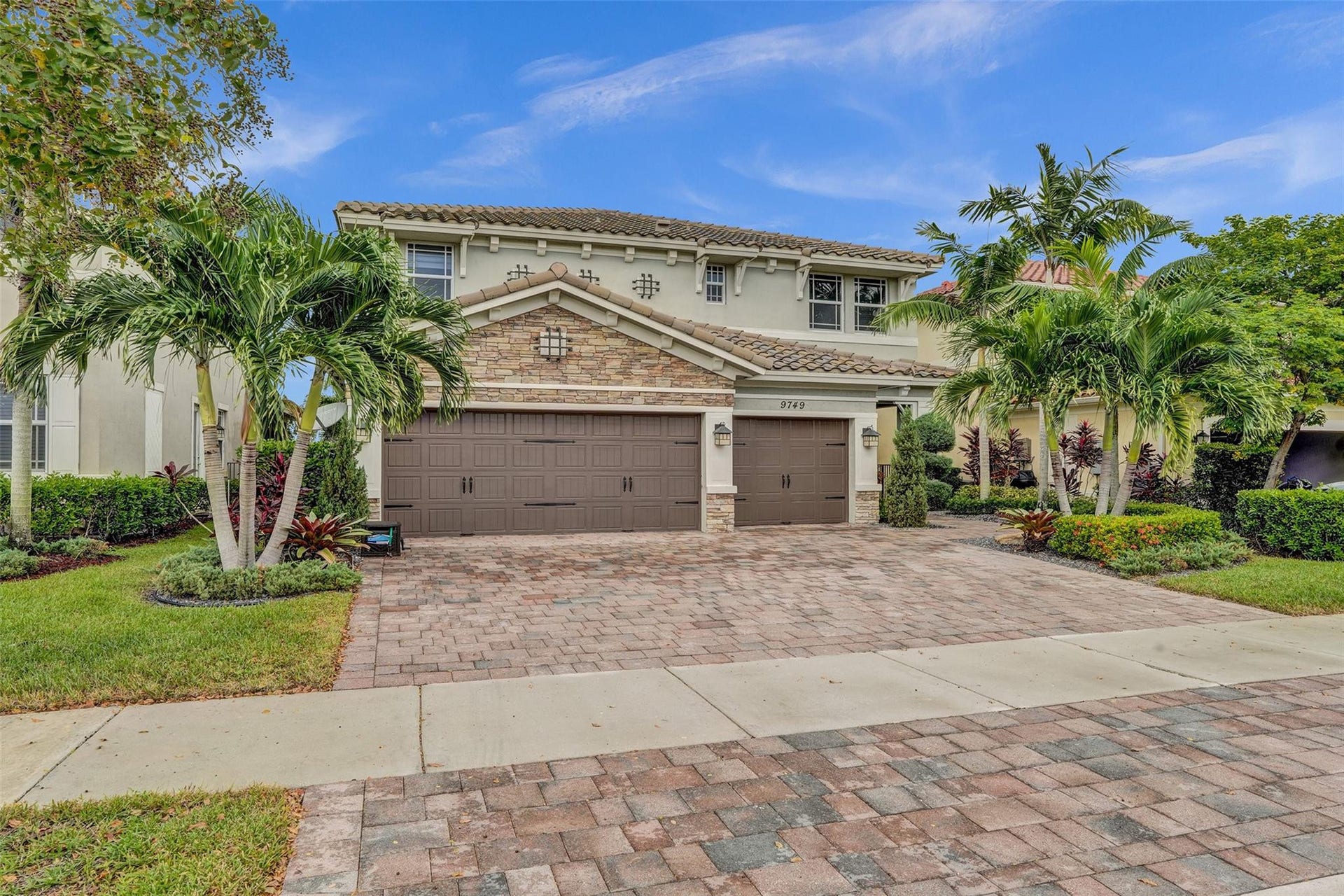 9749 Blue Isle, #BAY, Parkland, FL 33076 Brick paver driveway leading to a two-story stucco exterior with a tiled roof