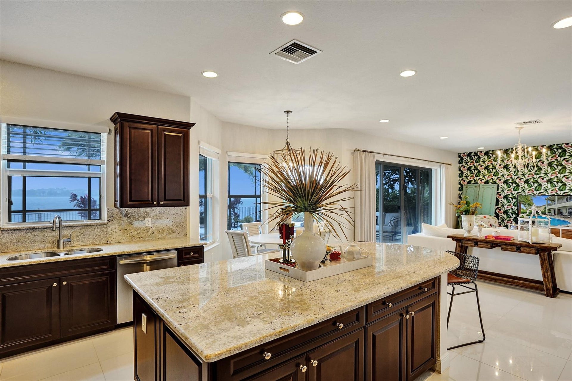 9749 Blue Isle, #BAY, Parkland, FL 33076 Gourmet kitchen featuring dark wood cabinetry, light-toned countertops, and a large central island