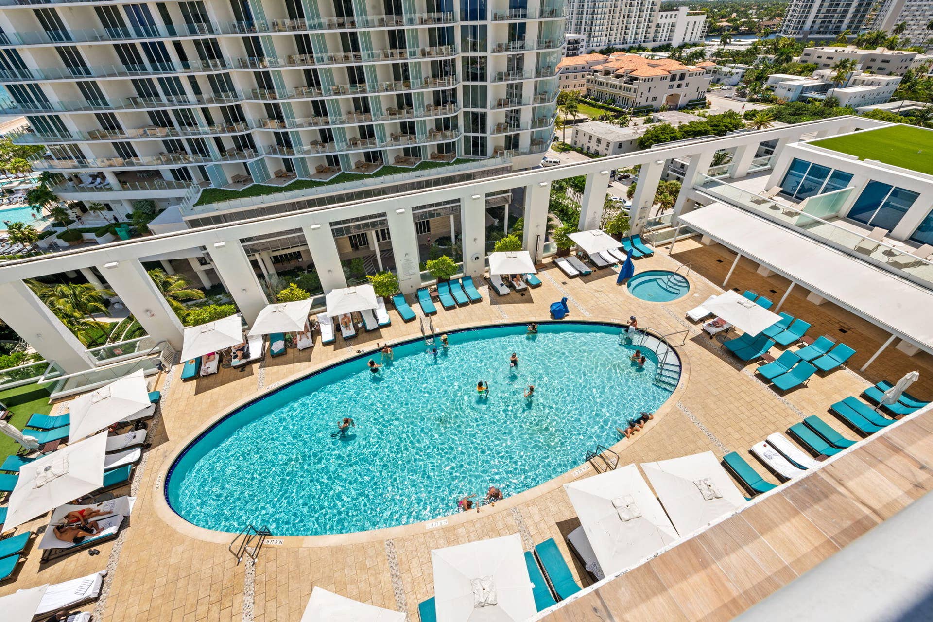 551 N FORT LAUDERDALE BEACH Boulevard, #H1011, Fort Lauderdale, FL 33304 Oval-shaped swimming pool with a spa, surrounded by a paved deck
