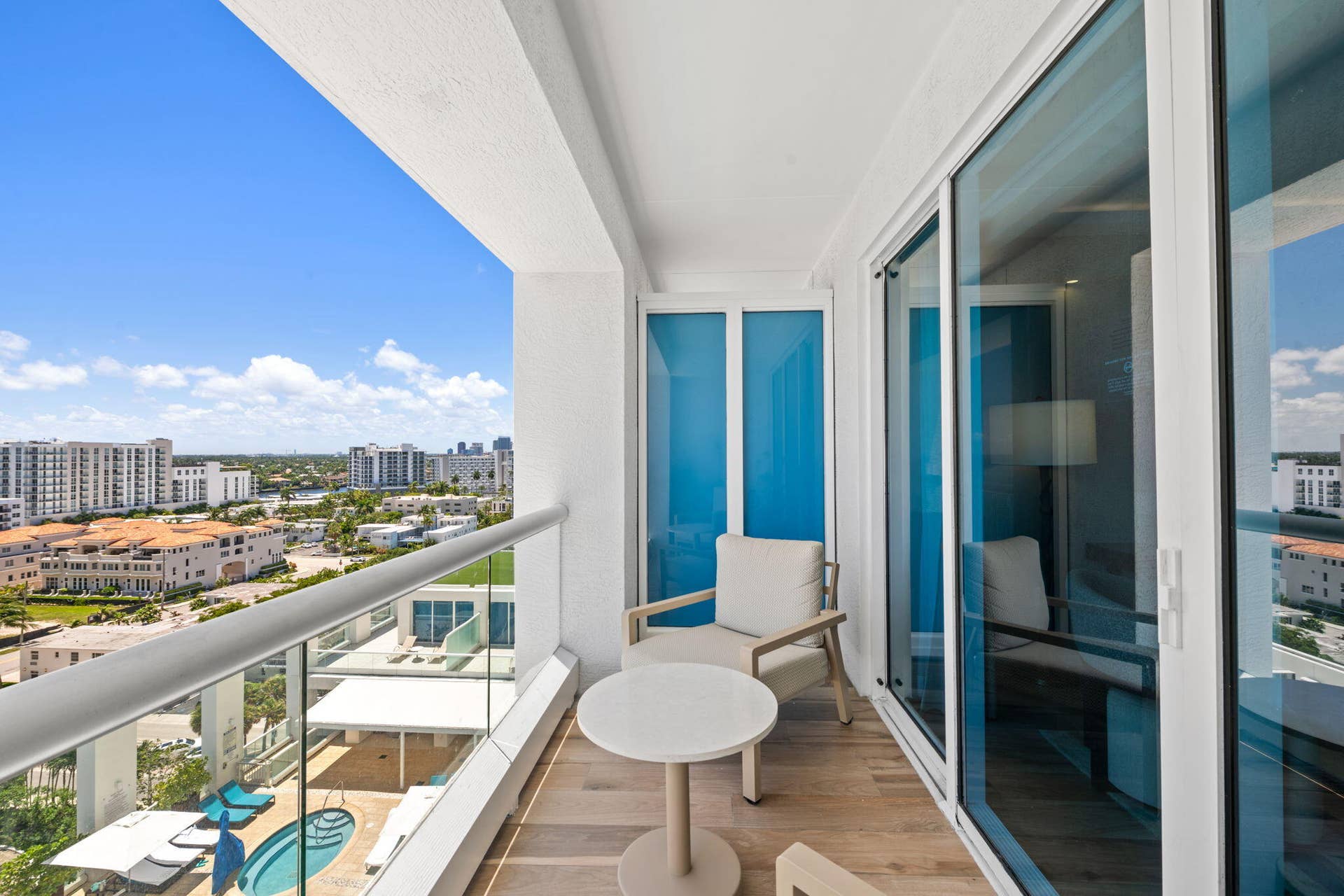 551 N FORT LAUDERDALE BEACH Boulevard, #H1011, Fort Lauderdale, FL 33304 Balcony featuring wood-finish flooring, glass railing, and sliding glass doors