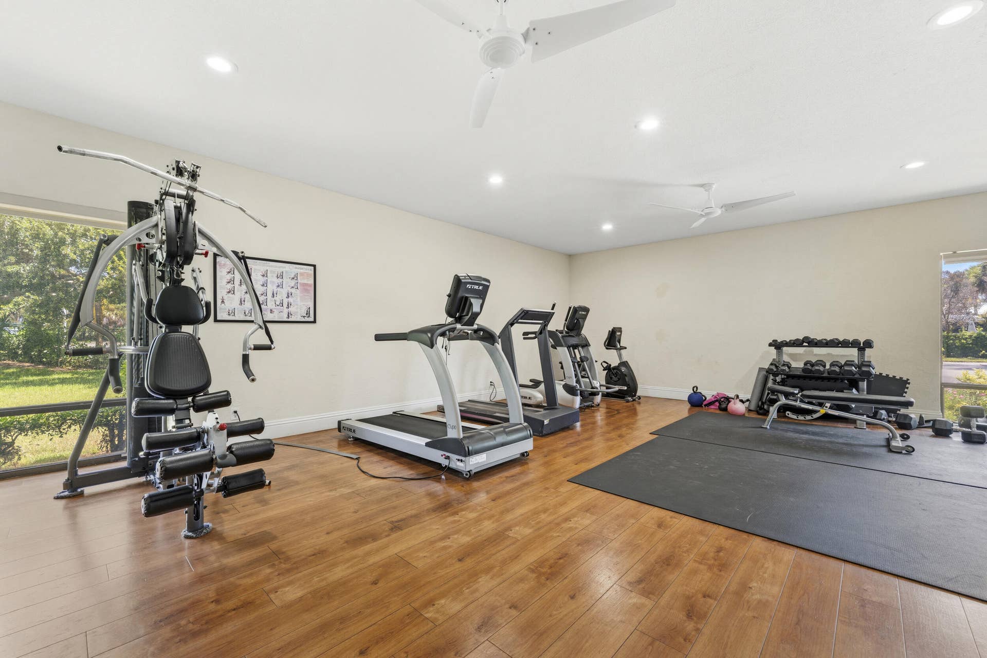 Dedicated fitness room featuring wood-finish flooring, recessed lighting, and ceiling fans