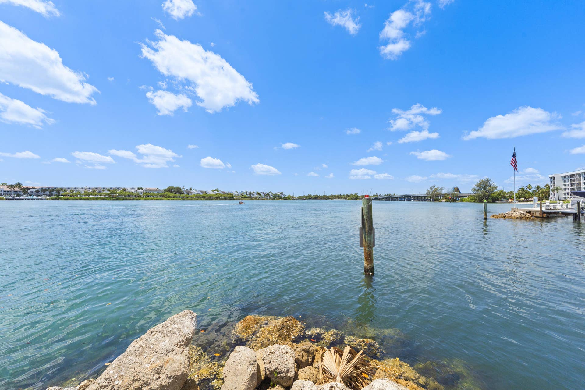 Waterfront setting with a built-in dock and distant bridge