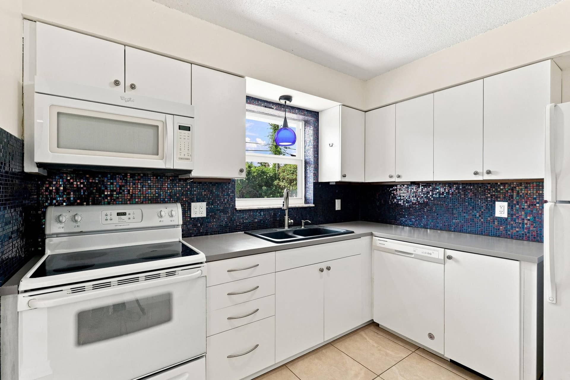 5114 Conklin Drive, Delray Beach, FL 33484 Additional kitchen view highlighting the cabinetry, counter space, and appliances.