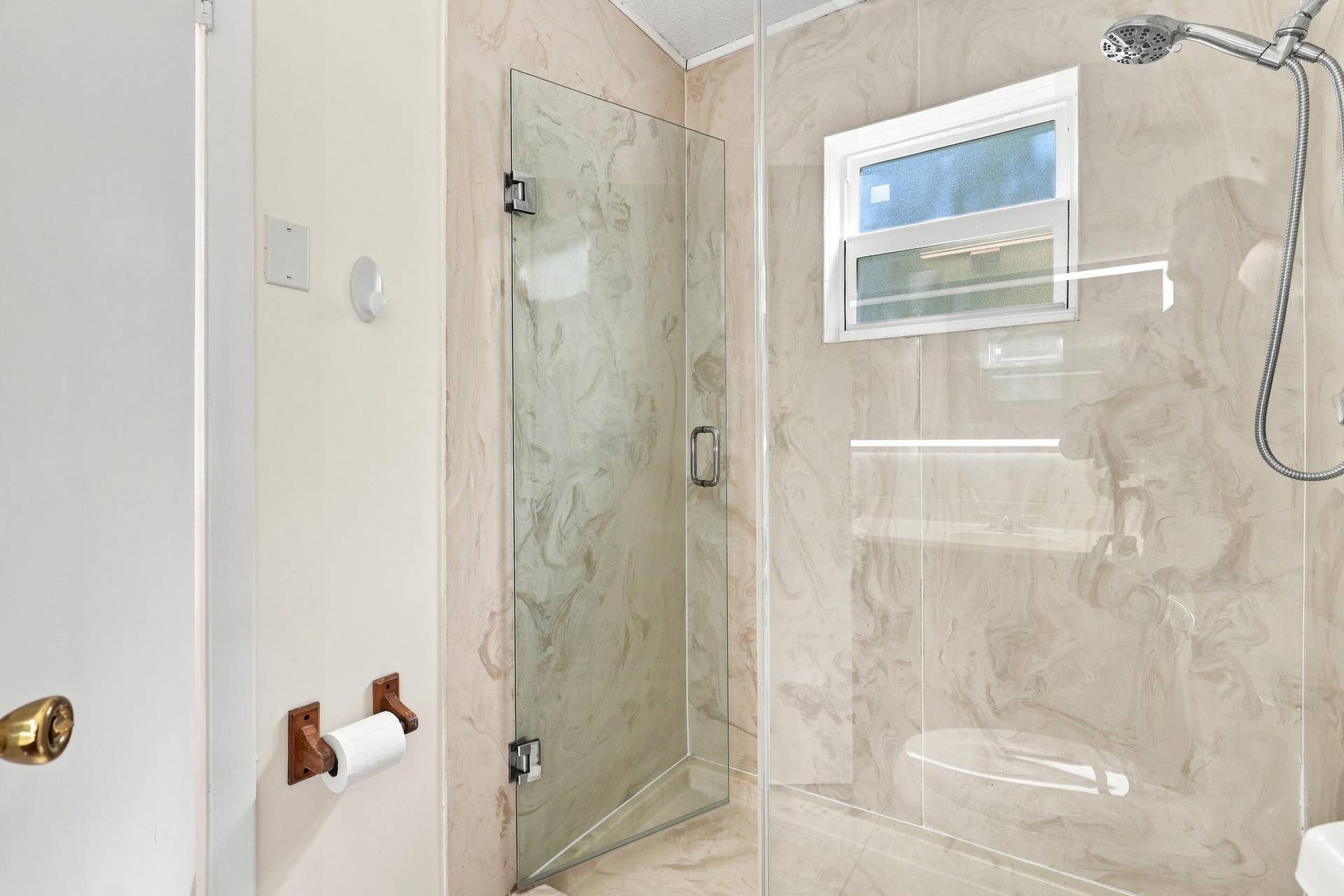 5114 Conklin Drive, Delray Beach, FL 33484 Updated shower featuring glass doors, tiled walls, and a window for natural light.