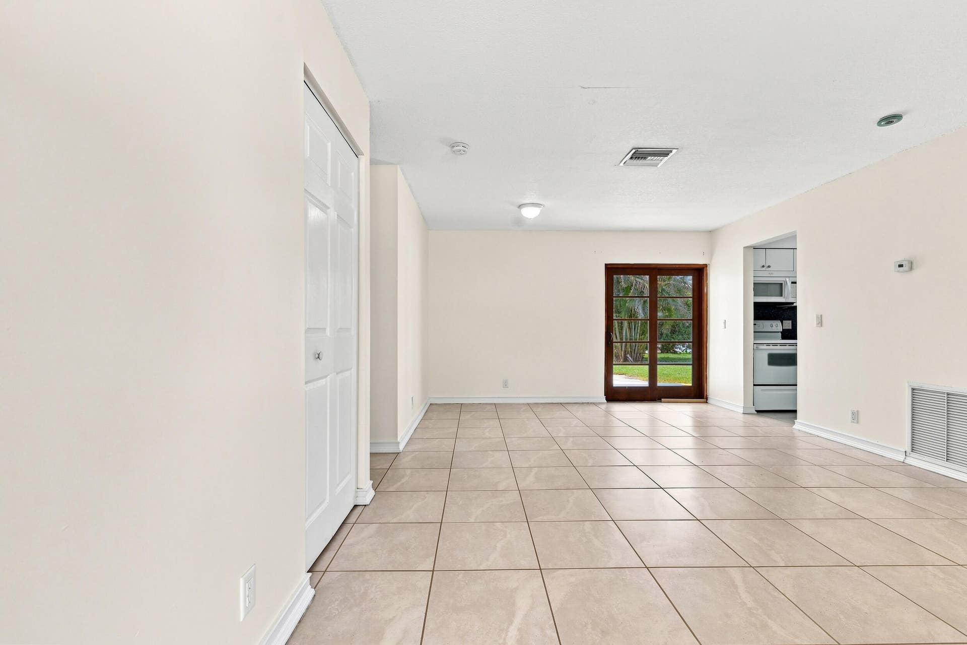 5114 Conklin Drive, Delray Beach, FL 33484 Bright tiled living area with recessed lighting and views toward the rear of the home.