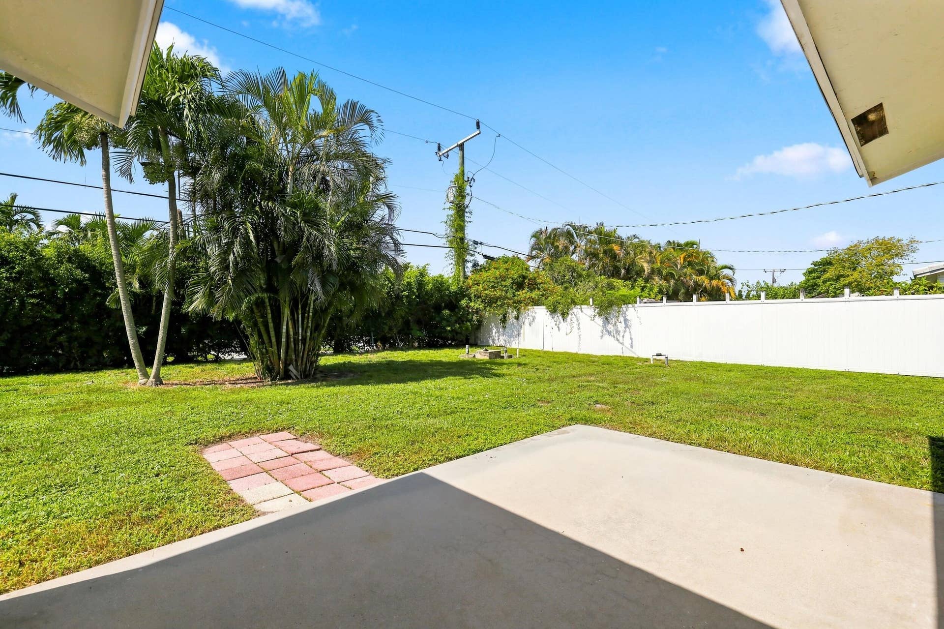5114 Conklin Drive, Delray Beach, FL 33484 Spacious backyard with patio area, mature landscaping, and plenty of open lawn.