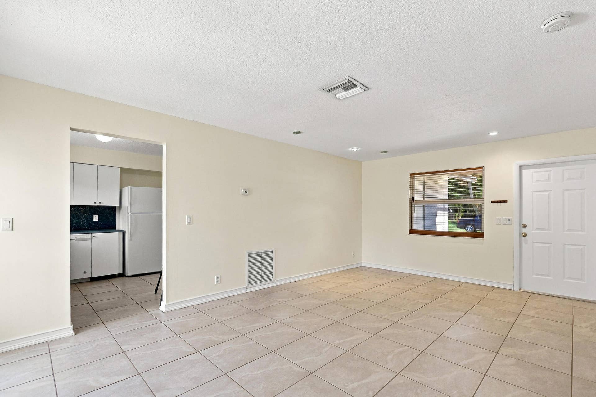 5114 Conklin Drive, Delray Beach, FL 33484 Open living area with tile flooring and convenient access to the kitchen.