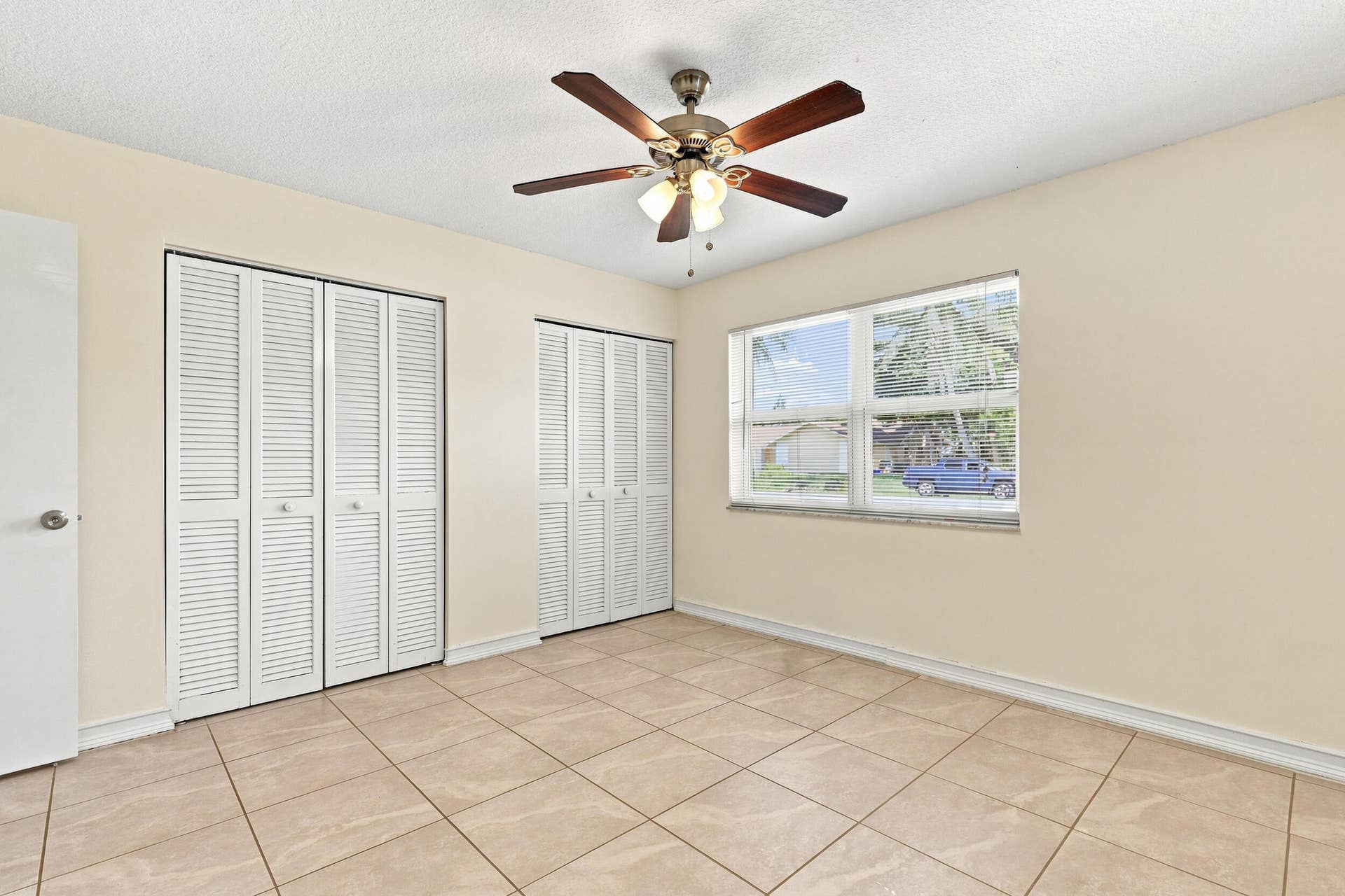 5114 Conklin Drive, Delray Beach, FL 33484 Spacious bedroom featuring tile flooring, ceiling fan, and generous closet space.
