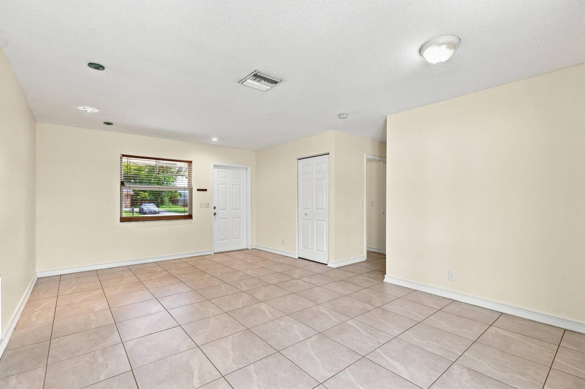 5114 Conklin Drive, Delray Beach, FL 33484 Spacious tiled interior with neutral walls and multiple windows for natural light.