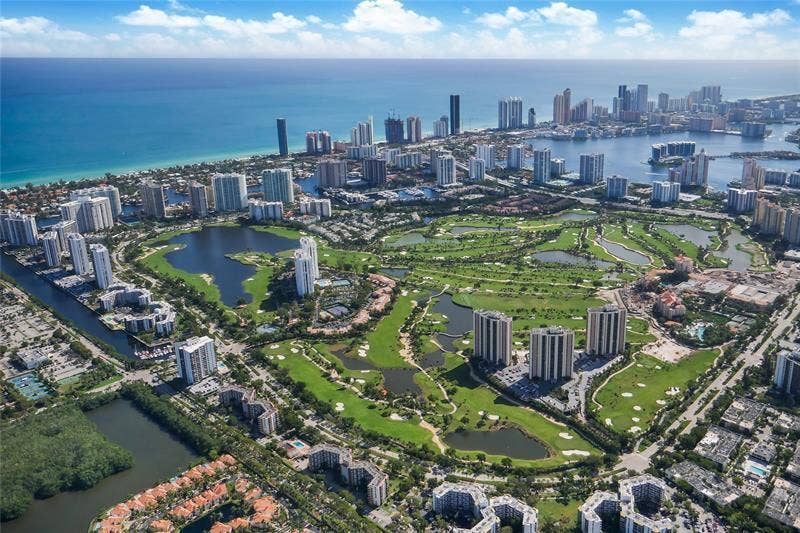 20335 W COUNTRY CLUB Drive, #2408, Aventura, FL 33180 Coastal urban setting with high-rise structures, multiple golf courses, and various bodies of water